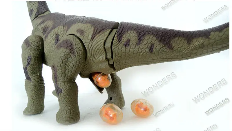 roheline elektriline dinosaurus, mis muneb oranže mune