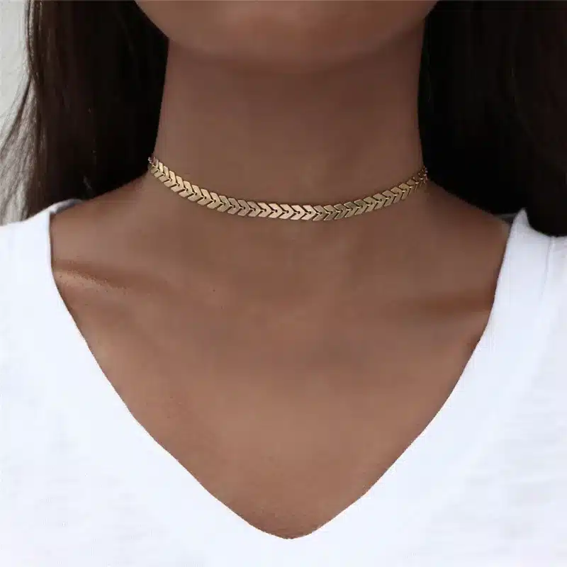 kuldne choker kaelakett valge pluusiga kaelal