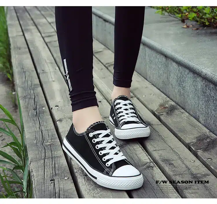 a person wearing black and white shoes