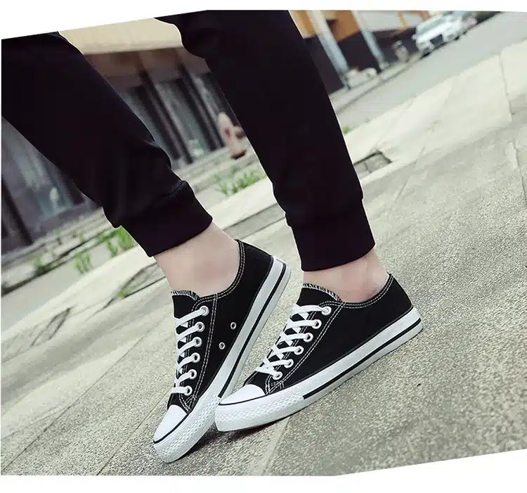 a person wearing black and white shoes