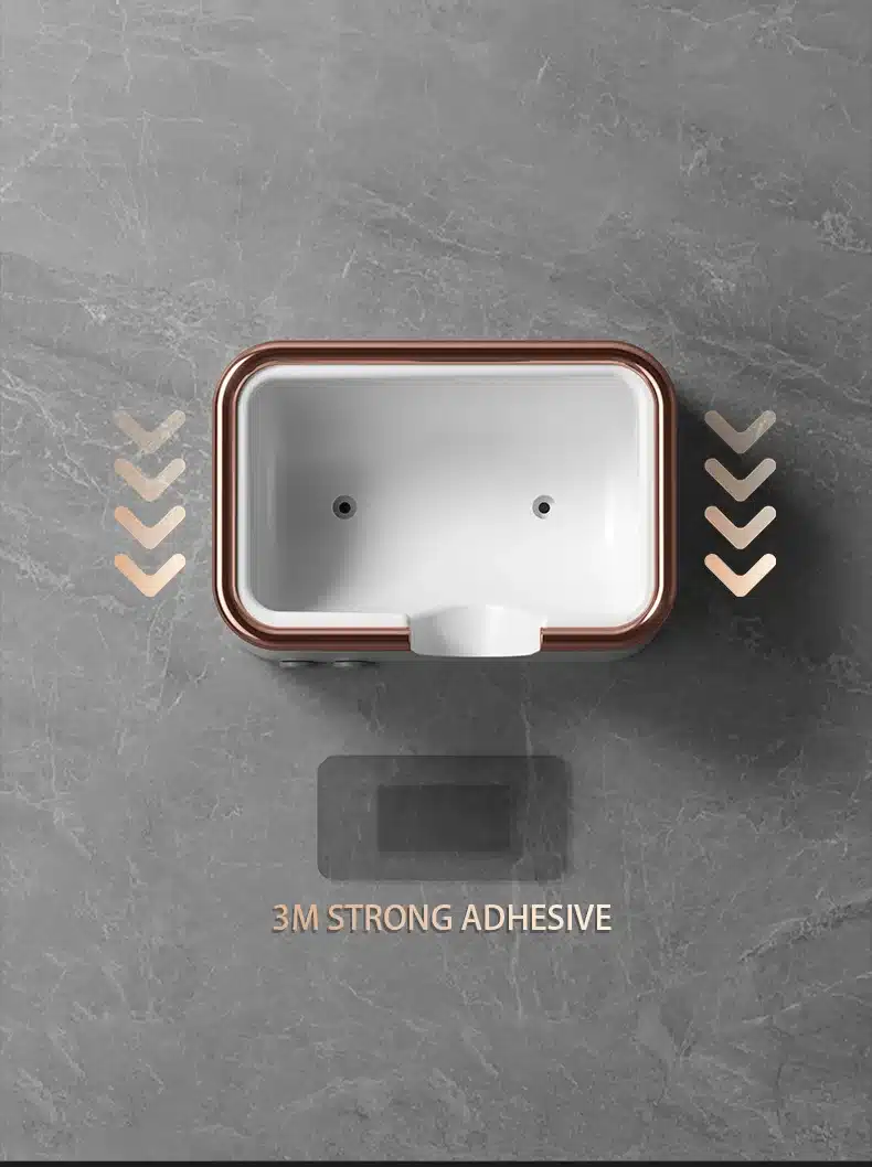 Väike seinale kinnitatav föön, mis on tugeva 3M liimiga kinnitatud halli marmorist seinale. Pildil on näha fööni kompaktne valge korpus, millel on pruun ääris, harmoneerudes neutraalse taustaga.