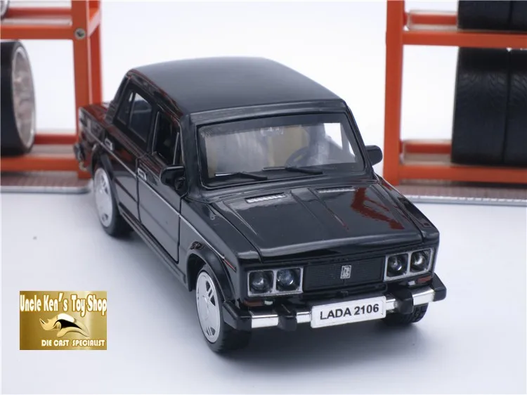 must miniatuurne auto, millel on neli ust ja hõbedased veljed