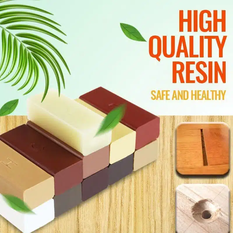 Erinevat värvi Parandusvaha puidu jaoks vardad puitlaual, taustal roheline leht ja tekts 'High Quality Resin'.