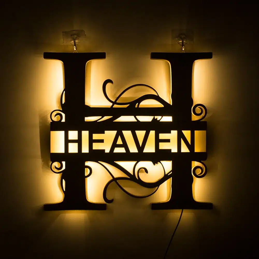 seinale kinnitatud LED lamp, mille keskmes on sõna 'heaven' ja kaunistatud keeruliste mustritega