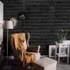 musta värvi veekindlad kleebitavad seinaplaadid elutoas, taustal valge mööbel ja taim
