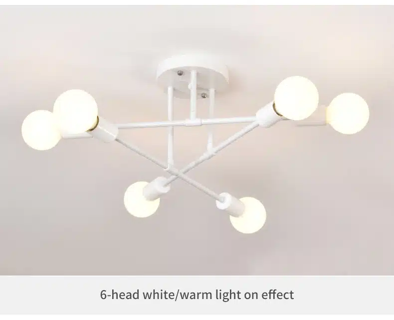 Valge modernne Moodsad 6 pirniga laelamp, mis on kinnitatud lae külge. Lampidel on ühtlane soojade toonidega valgustus, metallist raamistik on minimalistlik ja stiilne, pakkudes kontrasti heleda lae taustal.