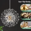 Kristalllaelamp ilutulestiku efektiga | E-pood Tootemaailm Lähedalt vaade Kristalllaelamp ilutulestiku efektiga koos läikiva roostevabast metallraami ja K9 kristalldetailidega mustal taustal. Lampi täiustavad mitmed G9 lambipesad, mille kaudu kiiguvad säravad valguskiired.