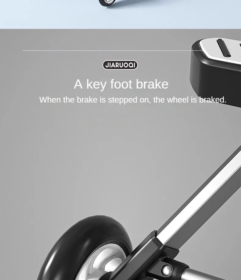 Kerge kahekohalise päikesevarjuga laste jalutuskäru must ratas ja turvaline pedaalpidur hallil taustal.