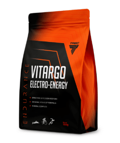 Elektrolüüt TREC VITARGO ELECTRO ENERGY sidruni-greibi maitsega pulber 1050 g mustas ja oranžis plastikpakendis, mis seisab valgel taustal.