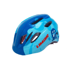 Lastekiiver LIMAR Kid Pro S, Ghost Blue, sinises toonis, kaunistatud lõbusate multikategelaste piltidega. Kiivril on kulumiskindel materjal ja head õhuavad mugavama sõidu tagamiseks. Taust on neutraalselt hall.