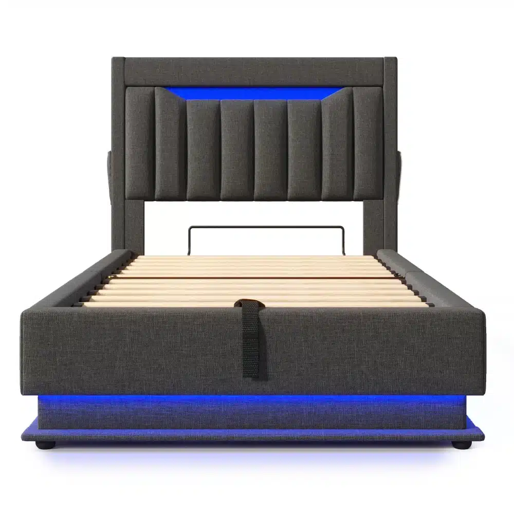 Hall linane üheinimesevoodi, millel on sisseehitatud sinine LED-valgustus, puidust rest ja USB-pesad, minimalistliku disainiga panipaigaga voodipeatsi all.