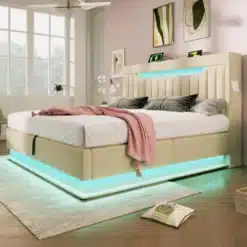 Elegantne polsterdatud voodi panipaiga ja LED valgustusega, beeži kangaga, kaunistatud pastelsete voodipesudega valgusküllases toas.