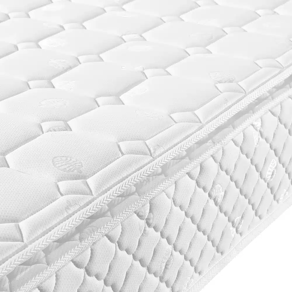 Close-up of a white, textured mattress surface showcasing its quilted pattern and soft fabric finish for a Noorukite voodi reguleeritava peatsiga, hall-beež bed.