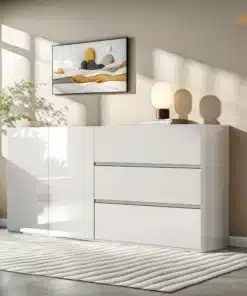 Stiilne kapp LED-valgustusega, valge läikiva viimistlusega, esitleb kahte ust ja kolme sahtlit avaras ja valgusküllases toas halli seina taustal.