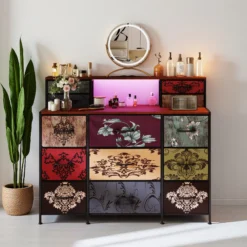 Kummut LED valgustusega, 13 sahtlit retro värviga, mitmevärviliste mustritega ja elegantse peegli taustal, toob ruumi unikaalset stiili. Toote peal asetsevad parfüümipudelid ja dekoratiivtaimed lisavad esteetikat.
