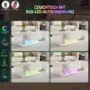 Diivanilaud LED valgustusega, läikiv lakk ja sahtlitega, 100x50x35, elutoas pehme vaiba taustal. Laud särab mitmevärvilise LED valgustusega, mille värvi saab reguleerida kaugjuhtimispuldiga.