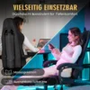 Soodne ergonoomiline kontoritool massaažiga kuni 150 kg | E-pood Tootemaailm Arvutitool massaažifunktsiooni ja nimmetoega, reguleeritav. Esiplaanil on naine toolil, mis on musta värvi ja nahast, heledas toas. Taustal on roheline taim ja neutraalne sein.