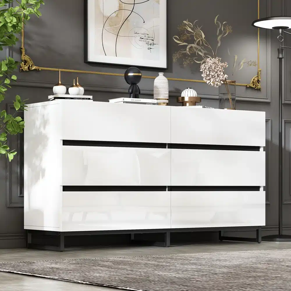 Valge kõrgläikega kuue sahtliga kummut elegantses elutoas, modernse disainiga, musta metallraamiga, sobib hästi luksusliku sisustusega.