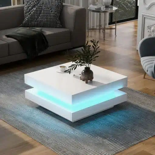 Diivanilaud LED valgustusega, pöörlev kandik, | E-pood Tootemaailm Kaasaegne valge diivanilaud LED valgustusega ja pöörleva kandikuga, asetatud hubases elutoas halli diivani kõrval heledal puidust põrandal.