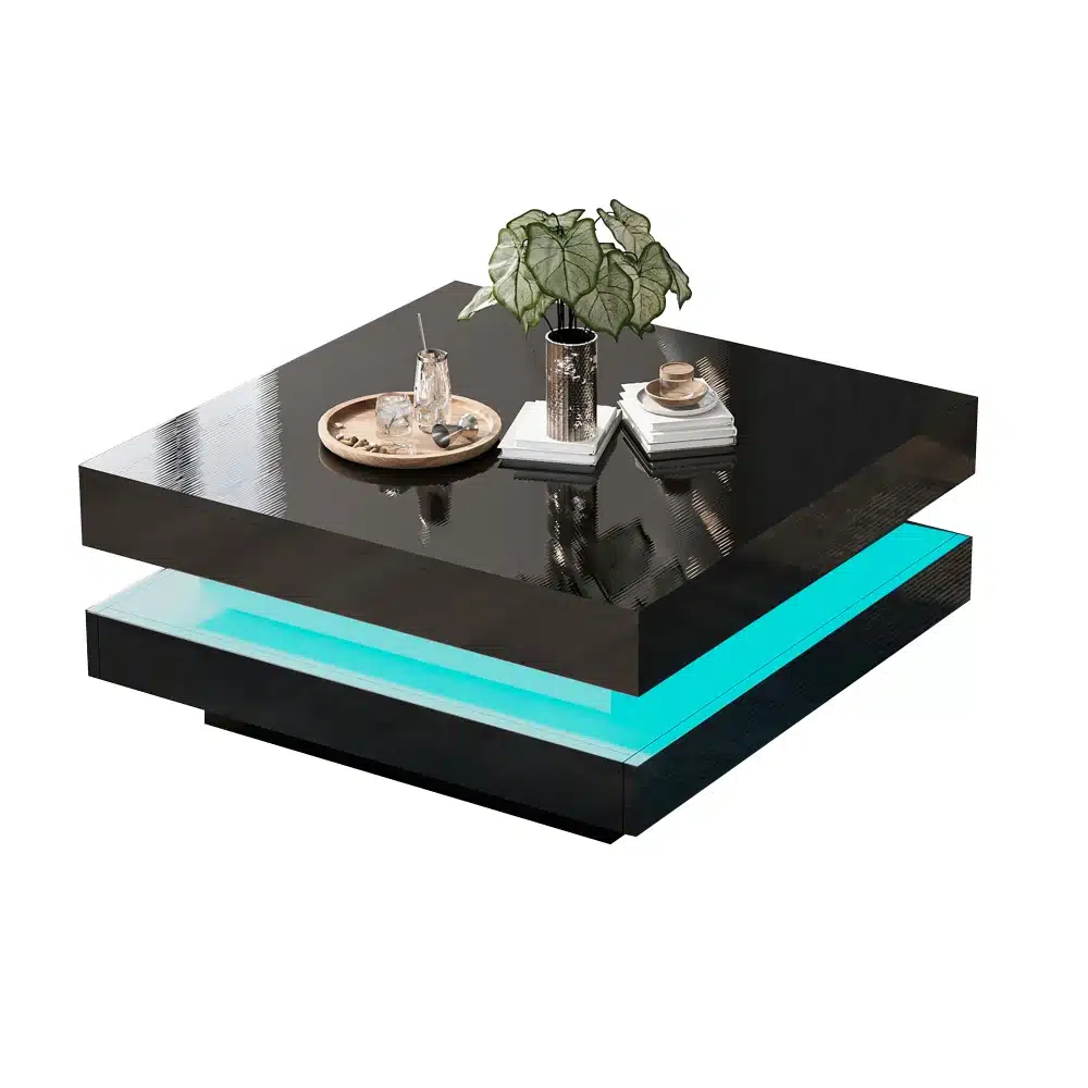 Diivanilaud LED valgustusega, pöörlev kandik ja must läikiv viimistlus, koos dekoratiivsete esemete ja raamatutega, taustal valge sein.