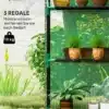 Kasvuhoone riiulitega UV-kaitsega roheline 143x74x190cm | E-pood Tootemaailm Kasvuhoone riiulitega, UV-kaitsega roheline 143x74x190cm, milles on mitu taimepotti. Taustal lopsakas rohelus ja päikeseline aed.