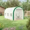 Kasvuhoone metallraamiga, valge, lukuga uksed, 3.5x2x2m | E-pood Tootemaailm Aias asuv valge kasvuhoone metallraamiga, millel on lukuga uksed ning mõõtmed 3.5x2x2m. Taustal on lopsakas rohevöönd ja lillepeenar, mis loovad rahuliku ja looduslähedase atmosfääri.