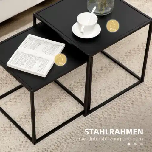Diivanilaudade komplekt mustast terasest, minimalistlik | E-pood Tootemaailm Kaheosaline diivanilaudade komplekt mustast terasest minimalistliku disainiga, pealmisel laual valge tass alusel ja teisel laual avatud raamat vaibal.
