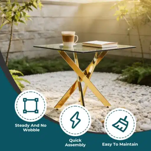 Söögilaud karastatud klaasiga, kuldsete metalljalgadega | E-pood Tootemaailm Söögilaud karastatud klaasiga, kuldsete metalljalgadega ning latte kohv ja raamat peal, asetsev modernses aias valgete kivide taustal.