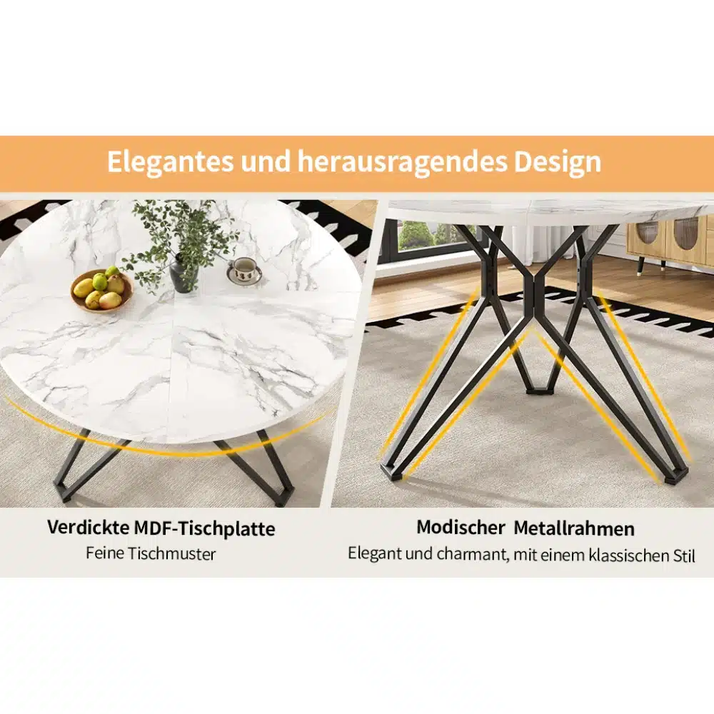 Ümmargune söögilaud marmorviimistlusega, 100x100 cm, mille peal on roheline taim ja puuviljakauss. Metallist jalad toetavad marmormustrilise plaadiga lauda heledal vaibal.
