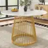 Ümmargune söögilaud elegantse marmorist plaadiga ja kuldsete jalgadega, paigutatud valgusküllasesse elutuppa koos puidust mööbliga.