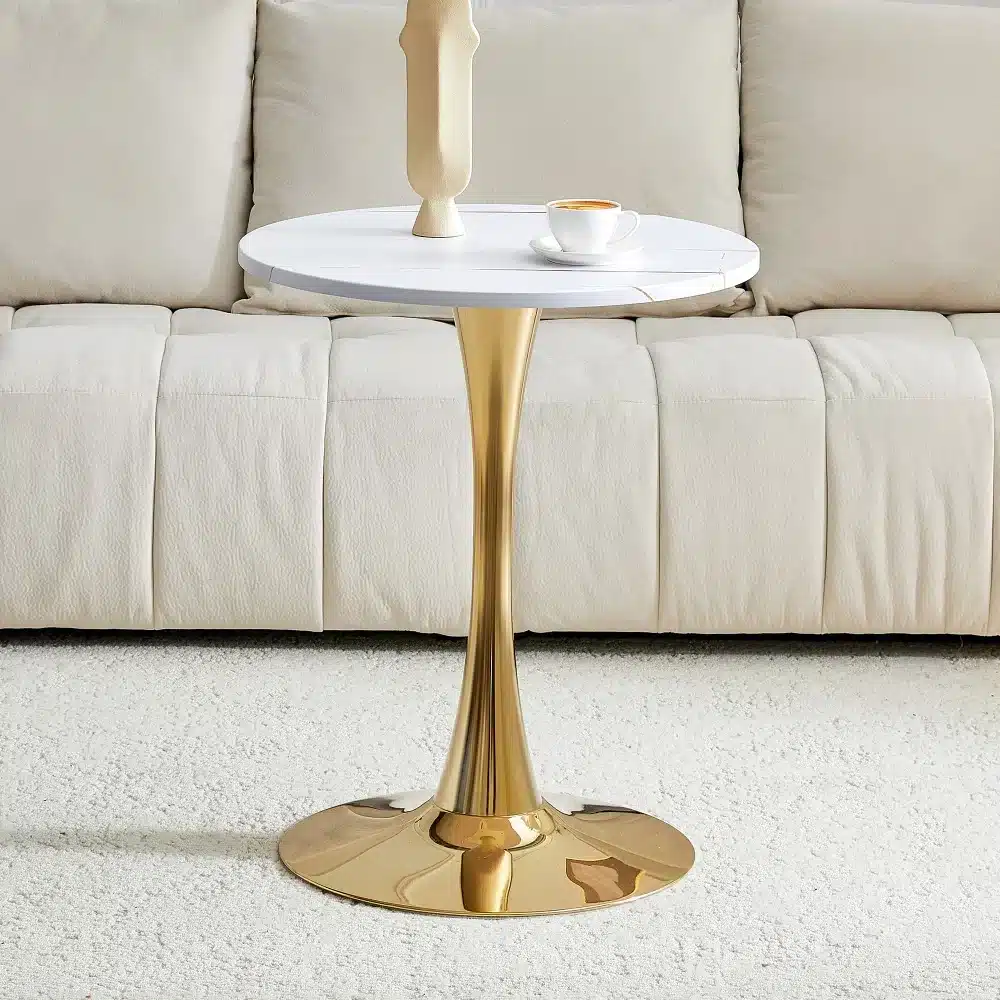 Ümmargune diivanilaud mõõtmetega 60 cm, valmistatud pähklipuu MDF materjalist, mis on varustatud kuldse metalljalaga. Taustal on pehme beež diivan, millel on dekoratiivne ese ja tass kohvi diivanilaual. Heledal vaibal laua ees loob hubase elutoa atmosfääri.