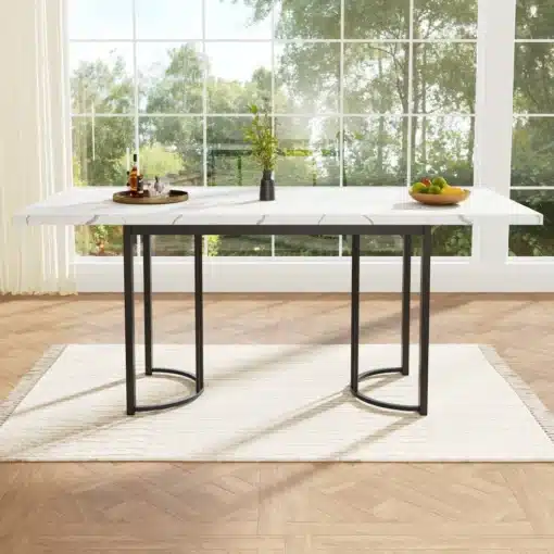 Laiendatav söögilaud metallraamiga, valge-must 140–180 cm | E-pood Tootemaailm Valge-must laiendatav söögilaud metallraamiga, asub avaras valgusküllases ruumis suure akna ees. Laud on osaliselt kaetud väikese taime ja puuviljakausiga.