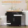 Ratastel köögikapp puidust tööpinnaga, millel on must korpus ja külgedel vürtsiriiul, käsitööriistad ning rätikualused, asub köögi puidust põrandal heledate seinte taustal.