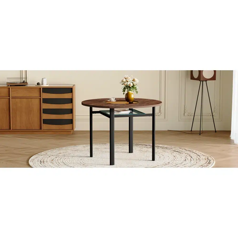 Ümmargused lauad puiduspooni ja klaasdetailiga elegantse ja minimalistlikus ruumis. Lauaplaat on tume puit, mille all asub läbipaistev klaasriiul. Taustal on hele sein ja puidust kapp.