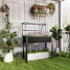Tõstetud istutuskast kasvuhoonekaanega, must 100x48x124 cm | E-pood Tootemaailm Must tõstetud istutuskast kasvuhoonekaanega, mõõtudega 100x48x124 cm, rohelises aias. Istutuskast on täidetud erinevate lilledega, kaitsva kaanega, ning taustal on valge puitsein ja rohelised taimed pottides.