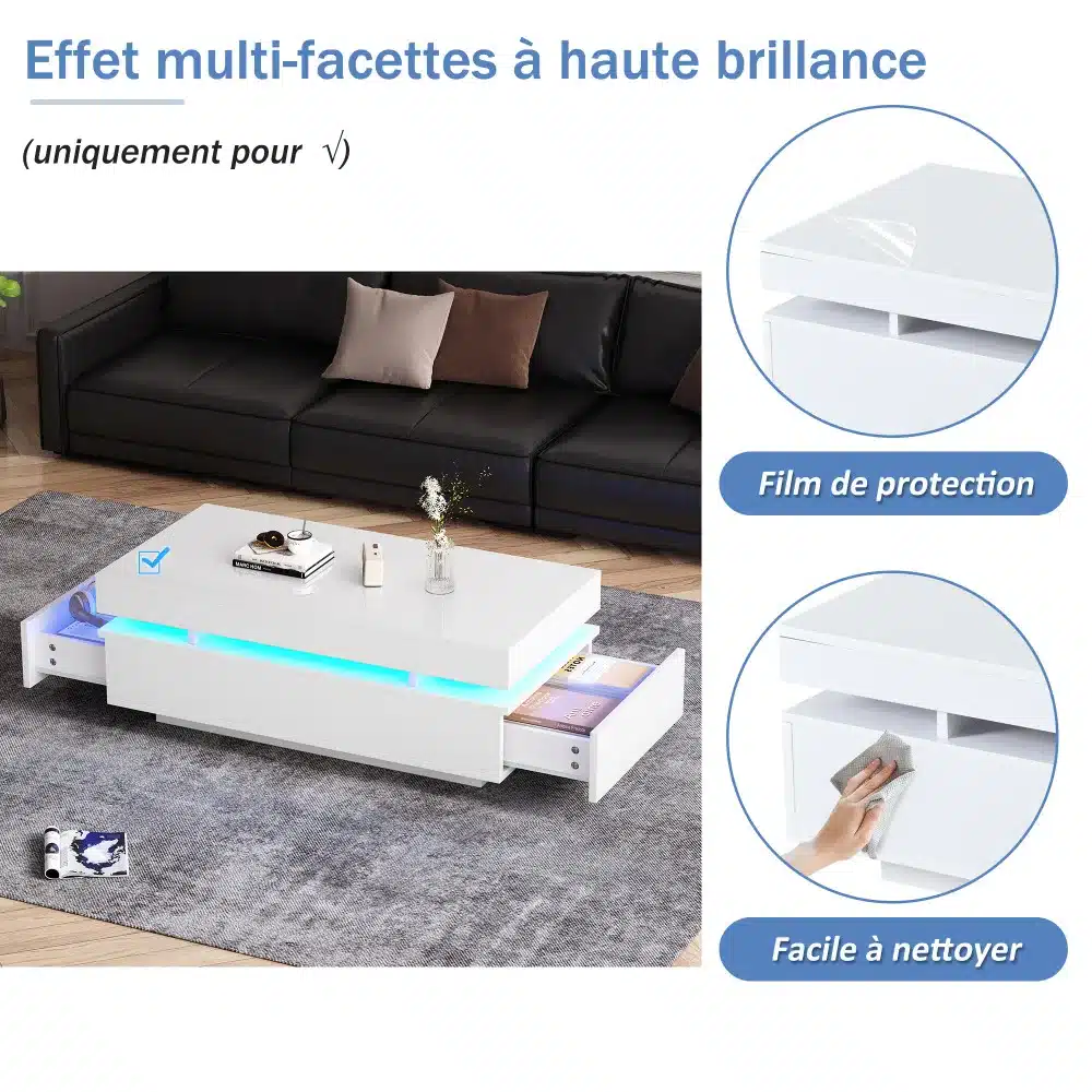 Kaasaegne valge diivanilaud LED-valgustusega ja kahe sahtliga, kõrgläike viimistlusega, asub šiki musta diivani ees minimalistlikus elutoas.
