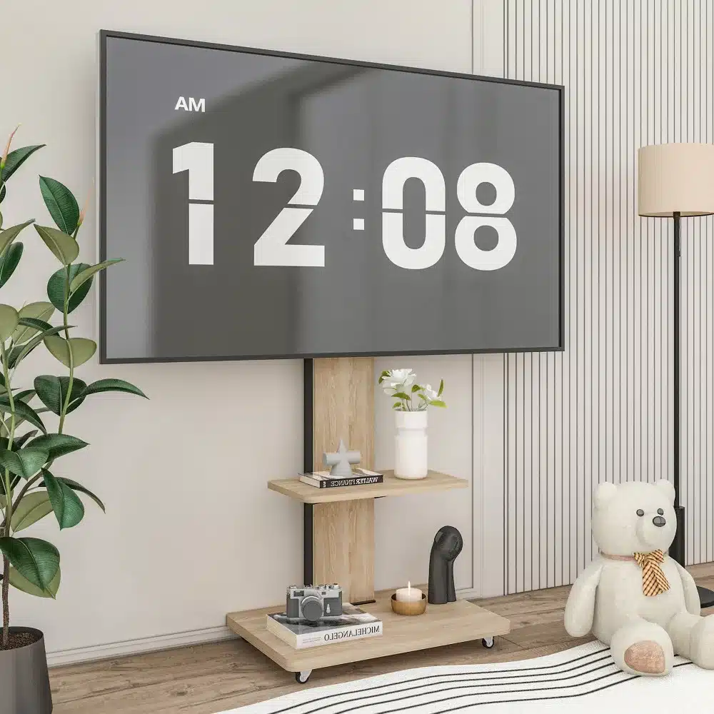 Telerialus ratastel, mille kõrgus on reguleeritav ja sobib 32–75-tollistele teleritele. Alusel on riiulid dekoratsiooniesemete jaoks ning see paikneb kodus, mille taustal on modernne elutuba valgete ja beežide elementidega.
