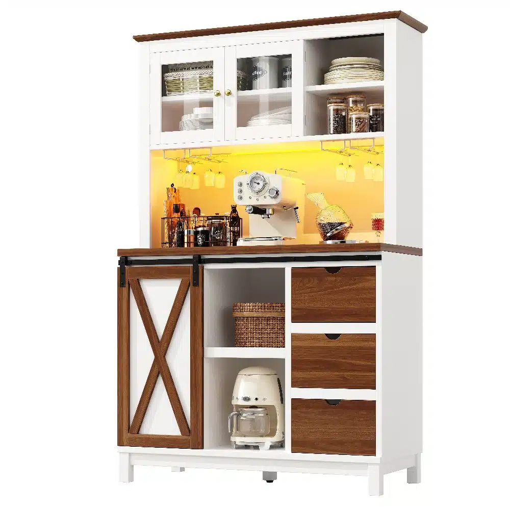 Set on a light-colored backdrop, the tall kitchen cabinet with LED lighting and sliding door showcases a combination of white and wood tones. Shelves display neatly arranged plates and jars, while the countertop features a coffee machine and decorative items. The sliding mechanism adds a modern touch, complementing the functionality with a warm LED glow.