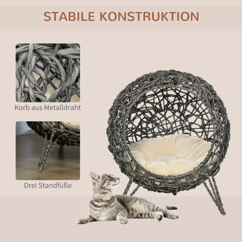 Kassimaja, rotangist pehmendusega, hõbehall toon Ø52x58 cm, tugev metalltraadist korv kolme jalaga, millel istub hall kass.