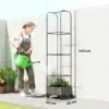 Kõrge aiakast trellisega ratastel, äravooluavaga 40x40x185 | E-pood Tootemaailm Kõrge aiakast trellisega ratastel, äravooluavaga 40x40x185, kus naine kastab taimi rohelise kastekannuga. Aiakast on musta metallist raamistiku ja pruuni alusega, mis seisab betoonpinnal valge seina taustal. Taimed kasvavad lopsakalt kastis.