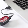 Jalgrattatulede komplekt Giant Recon HL 1100 ja TL 200 | E-pood Tootemaailm USB-ga ühendatud punane ja must taskulamp sülearvuti kõrval