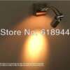 seinale kinnitatud metallist vannitoa lamp, mis kiirgab sooja valgust