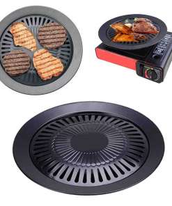 Ümmargune, must metallist taldrik grillimise jaoks, millel on spetsiaalsed grillribidega avad, asetatud punase laua-grillile, taldrik on kaunistatud erinevate lihadega.