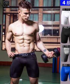 Sportlik mees hoiab hantlit kandes musti liibuvaid lühikesi pükse bodybuildinguks. Taustal on jõusaal.