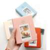64 taskuga polaroidfotoalbum Fujifilm Instax Mini filmi jaoks, sinine kaanega.
