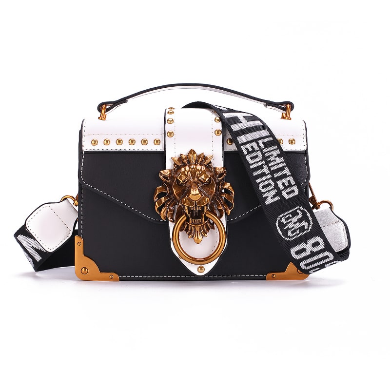Kuldse lõviga crossbody kott, musta värvi, metallist lõvipea detailiga esiküljel.