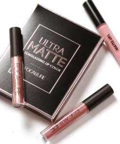 Kolm vedelat huulepulka mustas pakendis kirjadega 'Ultra Matte Longlasting Lip Color' ja 'Focallure'. Huulepulgad on erinevates roosades toonides mustade korkidega, asetatud valgele taustale.
