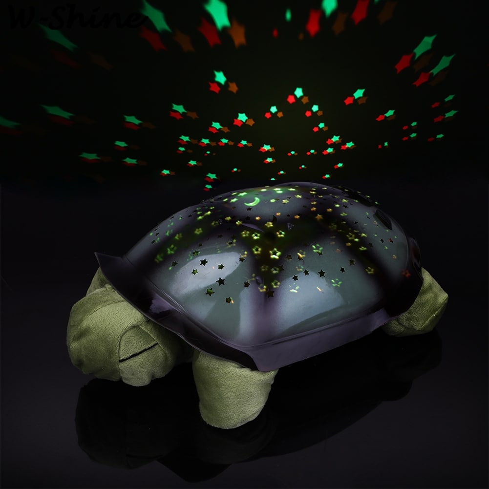 kilpkonna kujuline lamp, mis projitseerib tähistaeva mustreid seinale