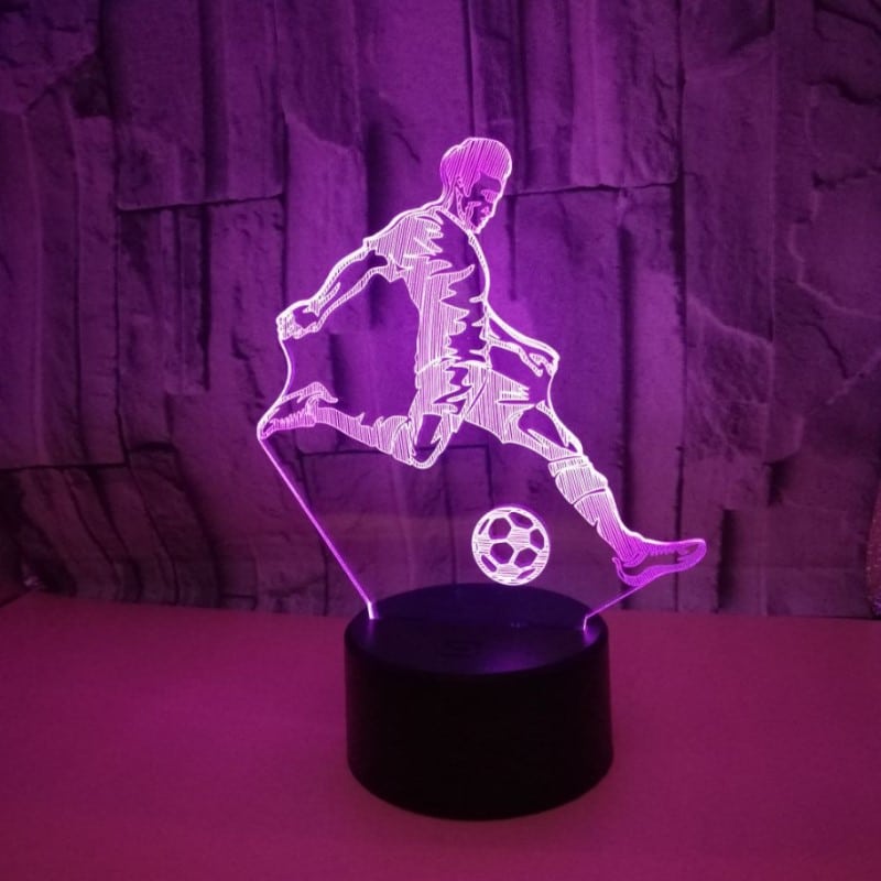 3D lamp jalgpalluriga mustal alusel valgustatud ruumis
