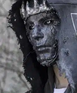 tumedates toonides mask, millel on krooni meenutavad detailid ja pragunenud tekstuur